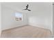 Bright bedroom with light wood floors, a ceiling fan, and a bright window at 6134 E Hannibal St, Mesa, AZ 85205