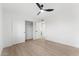 Bright bedroom features a modern ceiling fan, closet, and light wood floors at 6134 E Hannibal St, Mesa, AZ 85205