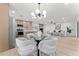 Modern dining area with glass table, adjacent to kitchen and living room with fireplace at 6134 E Hannibal St, Mesa, AZ 85205