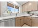 Close-up of the kitchen with modern countertops, stainless steel dishwasher, and view of the outside at 6134 E Hannibal St, Mesa, AZ 85205