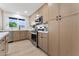 Bright kitchen featuring stainless steel appliances, natural wood cabinets, and a modern tile backsplash at 6134 E Hannibal St, Mesa, AZ 85205