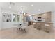 Stylish kitchen with stainless steel appliances, a dining area, and modern lighting fixtures at 6134 E Hannibal St, Mesa, AZ 85205