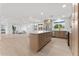 Open-concept kitchen with a central island, modern appliances, and seamless flow into the living area at 6134 E Hannibal St, Mesa, AZ 85205