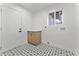 Laundry room with patterned tile flooring, storage cabinet, and door to the exterior at 6134 E Hannibal St, Mesa, AZ 85205