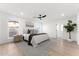 A bright main bedroom with white walls, ceiling fan, and a window view at 6134 E Hannibal St, Mesa, AZ 85205