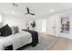 A light and airy main bedroom with a ceiling fan and access to a patio at 6134 E Hannibal St, Mesa, AZ 85205