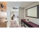 Inviting condo hallway with neutral tones and stylish accents lead into a naturally lit living space at 7960 E Camelback Rd # 209, Scottsdale, AZ 85251