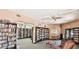 Cozy library with ample bookshelves, comfortable seating, and a welcoming atmosphere for reading and relaxation at 7960 E Camelback Rd # 209, Scottsdale, AZ 85251