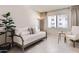 Bright living room with neutral tones, updated flooring, and large windows allowing ample natural light at 7960 E Camelback Rd # 209, Scottsdale, AZ 85251