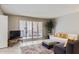 Cozy living room with a white sofa, stylish chairs, and a large window letting in natural light at 7960 E Camelback Rd # 209, Scottsdale, AZ 85251