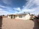 Home's backyard with stone groundcover and covered porch, perfect for outdoor living at 8217 E Medina Ave, Mesa, AZ 85209