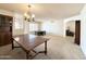 Traditional dining area with vintage chandelier, room for entertaining, and plantation shuttered window at 8217 E Medina Ave, Mesa, AZ 85209