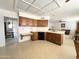 Cozy kitchen featuring wood cabinets, a built-in desk, and a practical layout at 8217 E Medina Ave, Mesa, AZ 85209