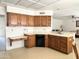 Kitchen featuring wooden cabinets, white countertops, and modern appliances with plenty of room at 8217 E Medina Ave, Mesa, AZ 85209