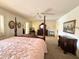 Spacious main bedroom featuring a traditional four-poster bed and abundant natural light at 8217 E Medina Ave, Mesa, AZ 85209