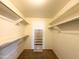 Walk-in closet with multiple shelves and organizational features for convenient storage at 8217 E Medina Ave, Mesa, AZ 85209