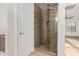 Glass door shower stall with dark brown pebble flooring and a tiled column at 9009 S 57Th Dr, Laveen, AZ 85339