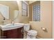 Cozy powder room with decorative tiles, a round mirror, and a vessel sink vanity with storage at 9009 S 57Th Dr, Laveen, AZ 85339