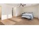 Expansive main bedroom with neutral carpet, ceiling fan and an abundance of natural light from the many windows at 9009 S 57Th Dr, Laveen, AZ 85339