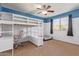 Bedroom featuring a loft bed and desk, plus a window and ceiling fan at 9009 S 57Th Dr, Laveen, AZ 85339