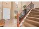 Inviting foyer with staircase, tile flooring, and ample natural light at 9009 S 57Th Dr, Laveen, AZ 85339
