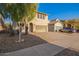 Two-story home featuring desert landscaping, attached garage, and a paved driveway at 9009 S 57Th Dr, Laveen, AZ 85339