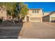 Inviting front exterior with desert landscaping and attached two car garage at 9009 S 57Th Dr, Laveen, AZ 85339