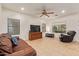 Spacious living room featuring tile floors, ample natural light and a comfortable leather sofa and recliner at 9009 S 57Th Dr, Laveen, AZ 85339