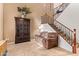 Open concept living room featuring tile floors, staircase, and natural lighting at 9009 S 57Th Dr, Laveen, AZ 85339