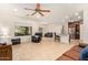 Open living room features tile floors, neutral walls and a comfortable leather sofa set, perfect for relaxing at 9009 S 57Th Dr, Laveen, AZ 85339