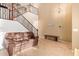 Bright living room featuring high ceilings, tile floors, and staircase at 9009 S 57Th Dr, Laveen, AZ 85339
