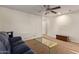 Comfortable loft with carpet, glass coffee table, and a sofa for a place to unwind at 9009 S 57Th Dr, Laveen, AZ 85339