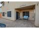 Inviting covered patio area with tile flooring, bench seating, and convenient access to the house at 9009 S 57Th Dr, Laveen, AZ 85339