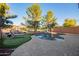 Backyard pool featuring manicured landscaping and turf, perfect for outdoor relaxation at 9009 S 57Th Dr, Laveen, AZ 85339