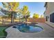 Backyard pool area features desert landscaping, mature trees, and a serene atmosphere at 9009 S 57Th Dr, Laveen, AZ 85339