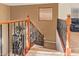Wooden and iron staircase ascends to the loft perfect as a design focal point at 9009 S 57Th Dr, Laveen, AZ 85339