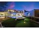 A lush backyard has a putting green, a hot tub, and a pool with lounge seating at 9735 E Kemper Way, Scottsdale, AZ 85255