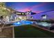 Landscaped backyard has a pool with a hot tub and putting green at 9735 E Kemper Way, Scottsdale, AZ 85255