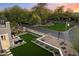 Cozy backyard sitting area with firepit, complemented by landscaped surroundings and neighborhood park at 9735 E Kemper Way, Scottsdale, AZ 85255