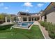 Lush backyard showcasing a pool, putting green, and expansive outdoor living areas at 9735 E Kemper Way, Scottsdale, AZ 85255