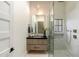Sleek bathroom with glass shower, vanity with dark countertop, and contemporary fixtures at 9735 E Kemper Way, Scottsdale, AZ 85255