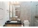 Stylish bathroom features gray tile, black countertop, and modern gold hardware in a well-appointed space at 9735 E Kemper Way, Scottsdale, AZ 85255