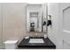 Modern bathroom with sleek fixtures, black countertop, and a large mirror reflecting a bedroom view at 9735 E Kemper Way, Scottsdale, AZ 85255