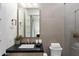 Stylish bathroom featuring modern fixtures, stone tile, and a sleek vanity at 9735 E Kemper Way, Scottsdale, AZ 85255