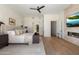 Spacious bedroom with modern fireplace, TV, neutral decor, and a glimpse into ensuite at 9735 E Kemper Way, Scottsdale, AZ 85255