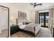 Tranquil bedroom with a plush bed, ceiling fan, and a private outdoor entrance at 9735 E Kemper Way, Scottsdale, AZ 85255