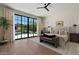 Bright bedroom featuring a large window with pool view, hardwood floors, and neutral, modern decor at 9735 E Kemper Way, Scottsdale, AZ 85255