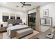 Spacious bedroom with a comfortable bed, bench, and private access to the outdoors at 9735 E Kemper Way, Scottsdale, AZ 85255
