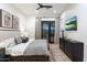Elegant bedroom with a decorative rug, ceiling fan, and a private outdoor entrance at 9735 E Kemper Way, Scottsdale, AZ 85255