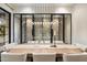 Elegant dining room showcasing a modern table setup with wine storage and sophisticated lighting at 9735 E Kemper Way, Scottsdale, AZ 85255